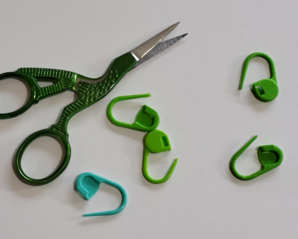 scissors and stitch markers